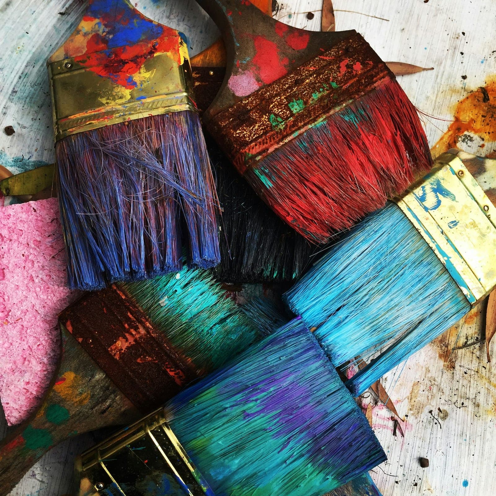 Hands creating colorful abstract art with paint