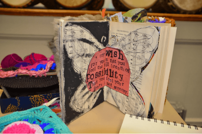 An altered book with a butterfly collage and the words wish and possibility, made in Writing Studio